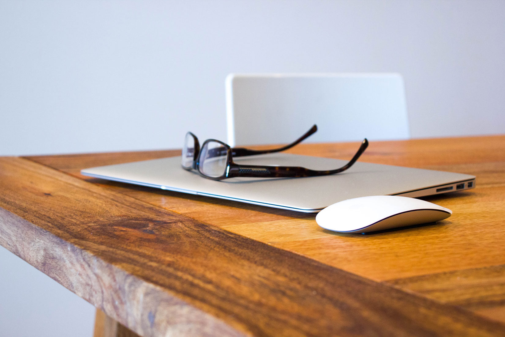 Laptop showing a website wireframe beside a pencil sketch of a homepage layout.