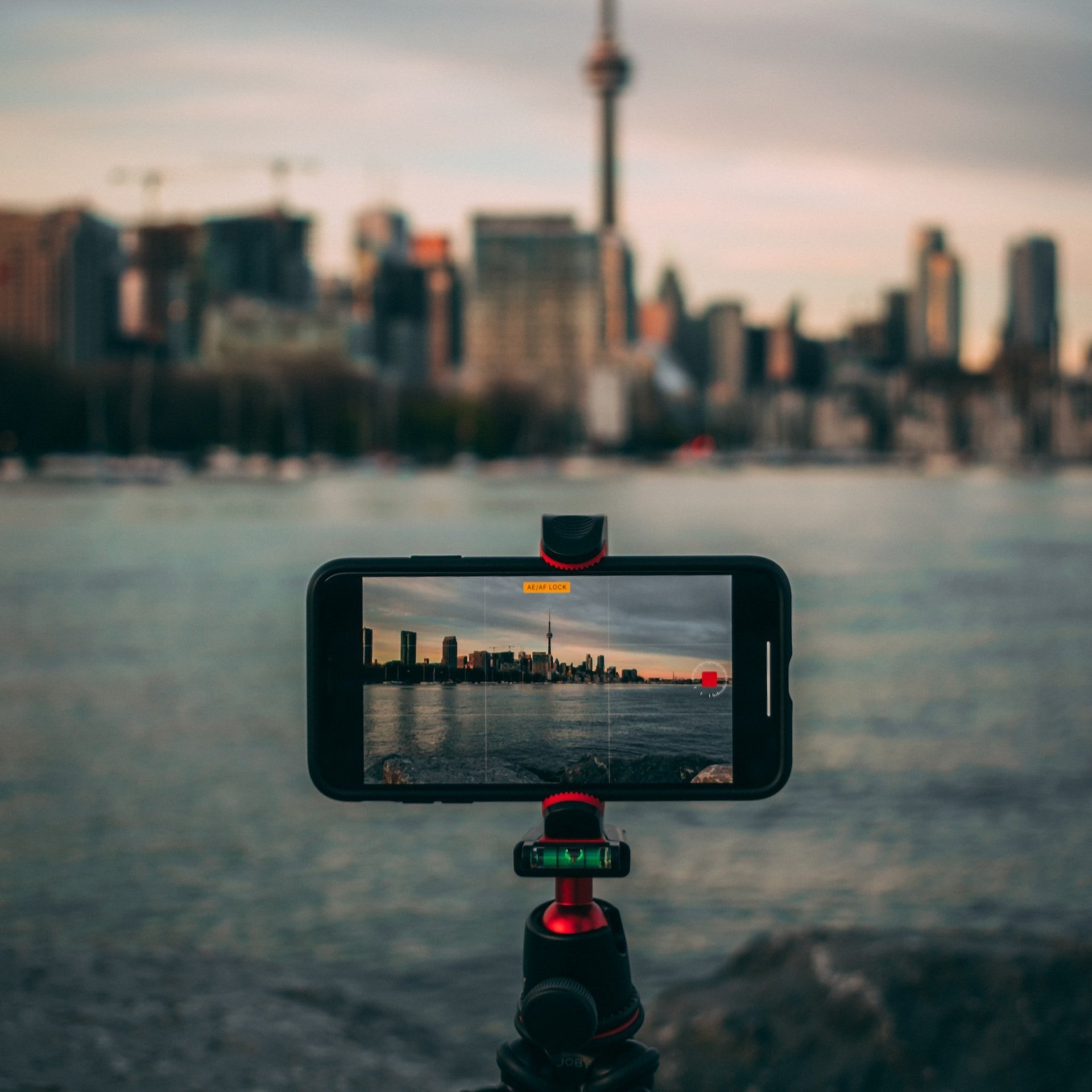 Black smartphone mounted on a small flexible tripod.