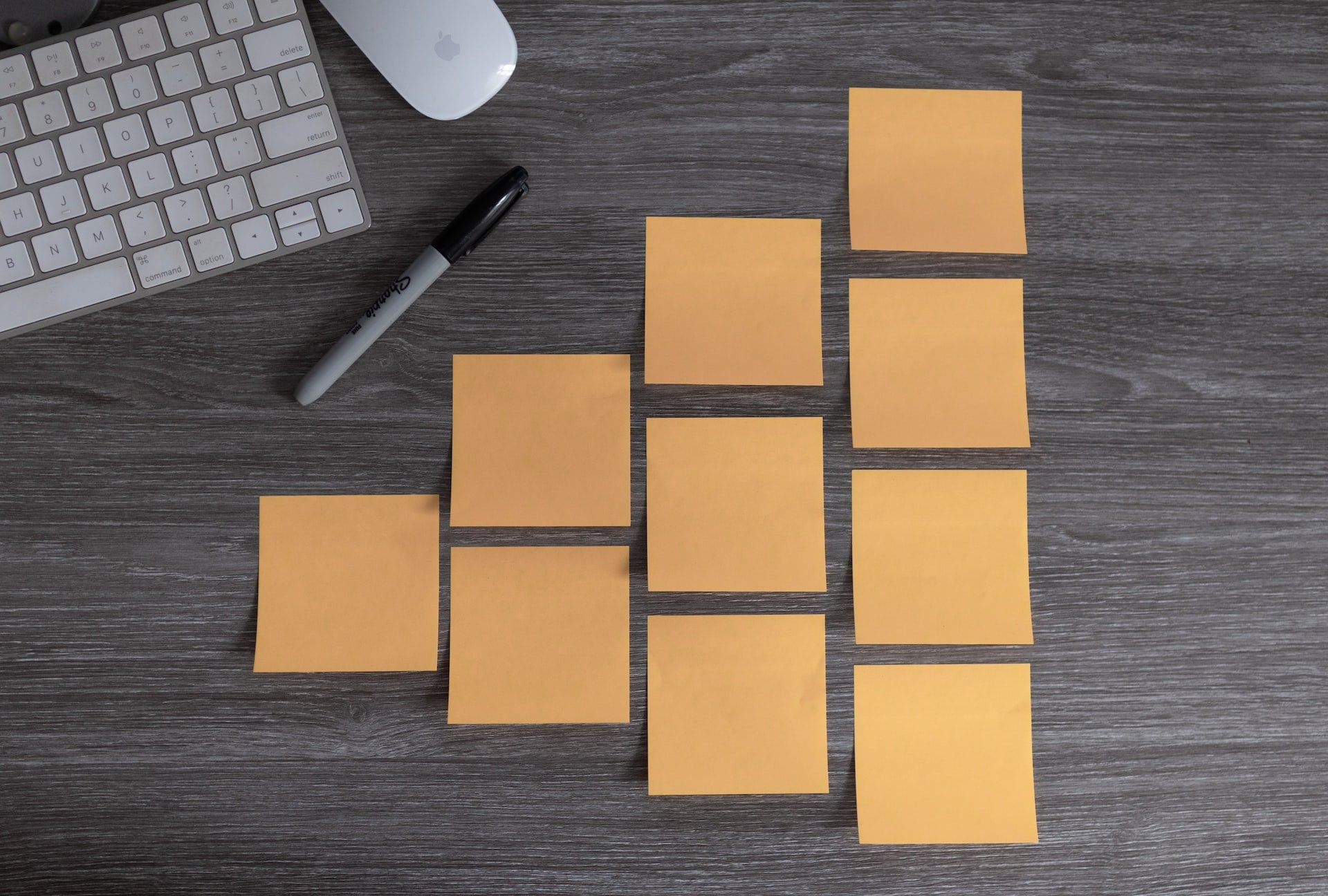 Grid of pastel sticky notes on a white wall.